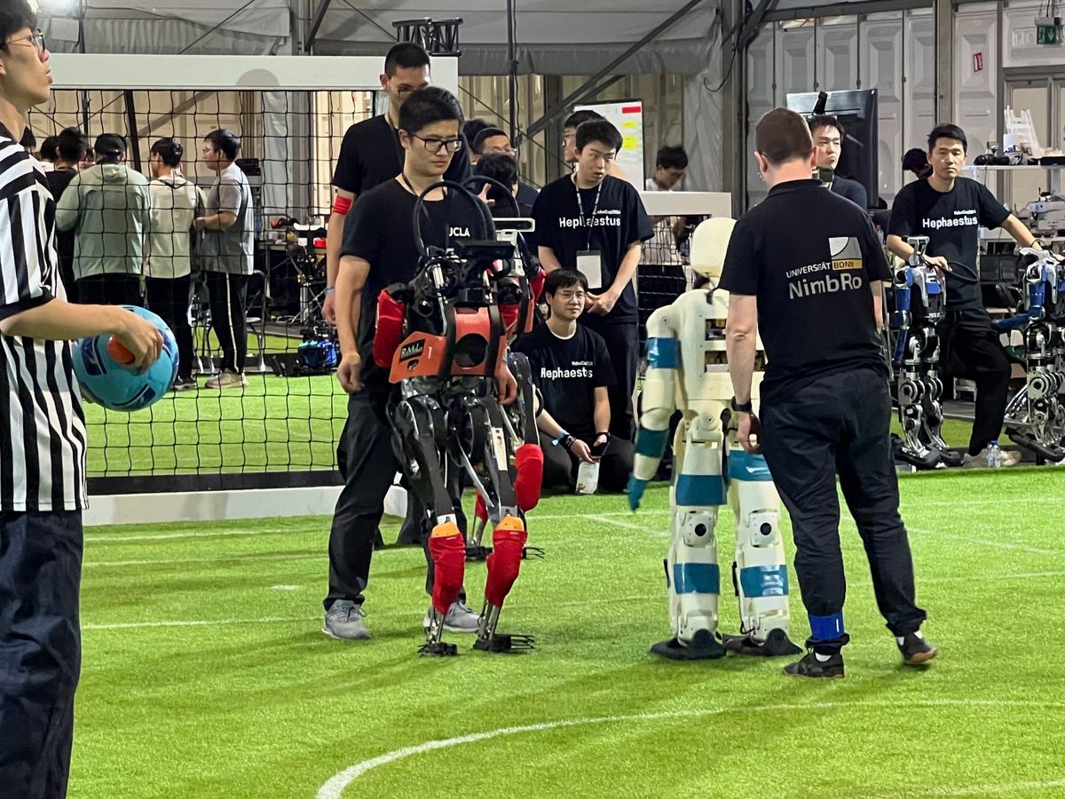 The UCLA team walking the humanoid robot ARTEMIS onto the field at RoboCup